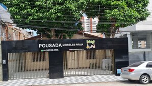 A gated entrance to a property named Pousada Meireles Praia with a contact number and social media handle visible. - Pousada Meireles Praia (Fortaleza)