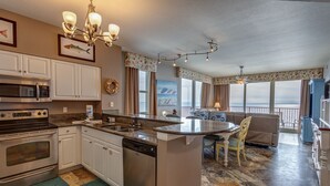 A spacious kitchen with modern appliances, a dining area with a view, and a cozy living room. - 3 Bedroom in Shores of Panama - Penthouse with amazing views! (Panama City)