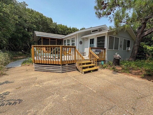 A two-story cabin with a deck and stairs leading to the entrance. - Atlantic Shanty - Quaint 3 BR Oceanside home in Southern Shores (Southern Shores)
