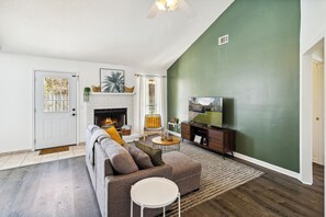 Relax in this inviting living room with a comfortable sofa, coffee table, and fireplace.