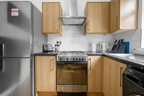 Fridge, microwave, coffee/tea maker, cookware/dishes/utensils