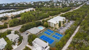 An aerial view of a residential area with a large building featuring multiple tennis courts and a swimming pool. - 30A Perfect for 2-Private Beach-Tennis/ Pickle ball/Tesla Universal EV Charger (Santa Rosa Beach)