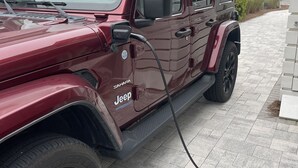 A maroon Jeep Wrangler parked on a paved driveway. - 30A Perfect for 2-Private Beach-Tennis/ Pickle ball/Tesla Universal EV Charger (Santa Rosa Beach)
