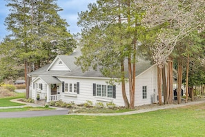 A single-story house with a front porch, a small garden, and a driveway.