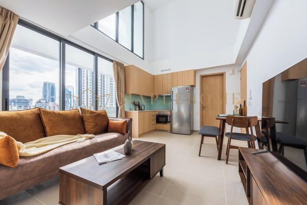 A modern living room with a sofa, coffee table, and dining area.