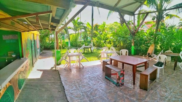 An outdoor patio with a covered seating area, a table, and chairs. - Vampayá Panamá (Bocas del Toro)