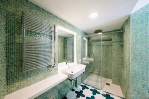 Bathtub, hair dryer, towels, toilet paper