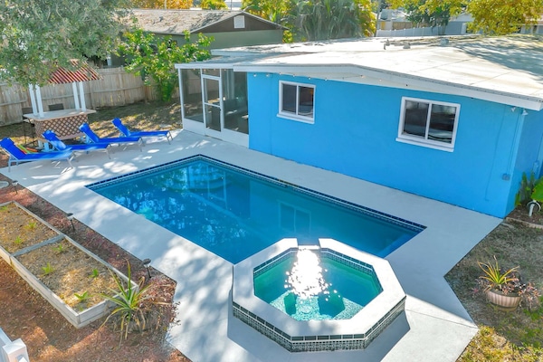 Aerial view of backyard, pool, & patio.