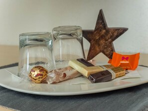 Indulge in a selection of gourmet treats, including a wrapped Bailey's Ball, chocolate, cheese, and pankechon.