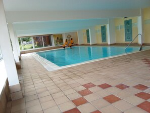 Relax by the pool, surrounded by lush views and comfortable seating.