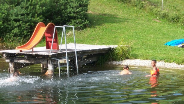 A water park with a small wooden platform featuring a slide and a ladder. - Apartment in Bleiburg Near the ski Resort (Feistritz ob Bleiburg)