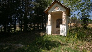 A small, white chapel with a triangular roof, surrounded by trees and grass. - Apartment in Bleiburg Near the ski Resort (Feistritz ob Bleiburg)