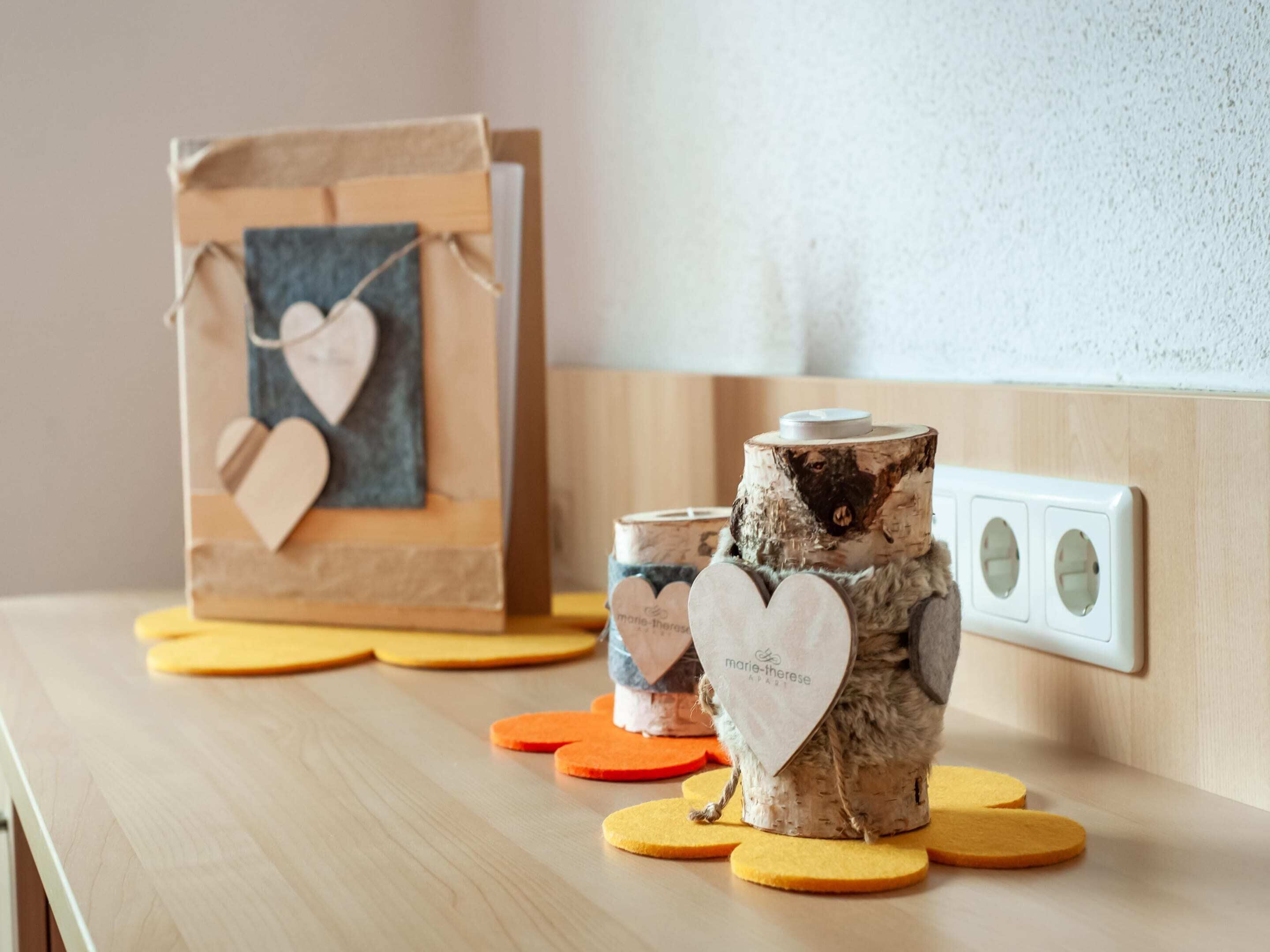 A wooden table with a decorative item, a small wooden box, and a candle holder.