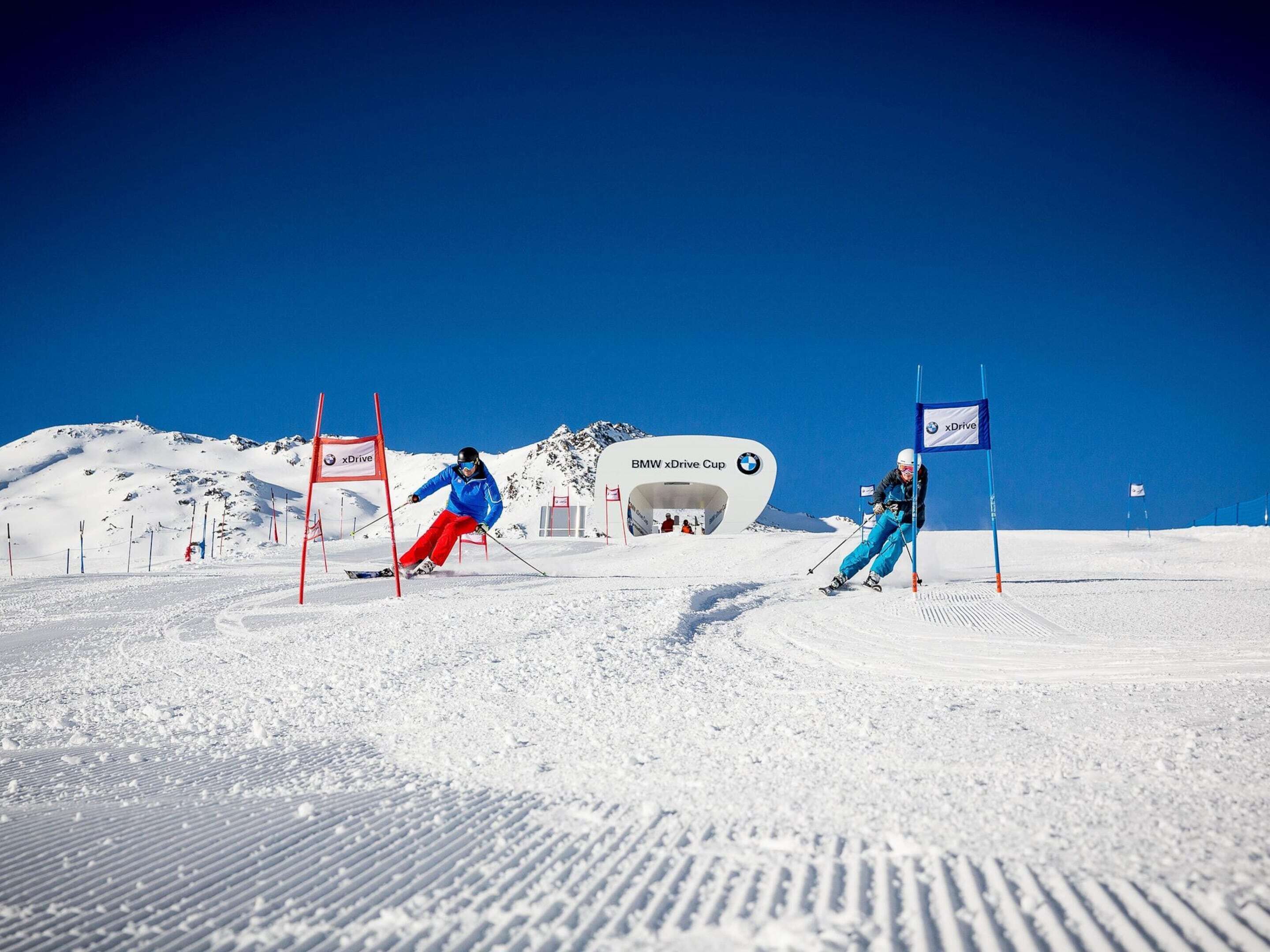A ski slope with marked boundaries and a BMW xDrive Cup sign.
