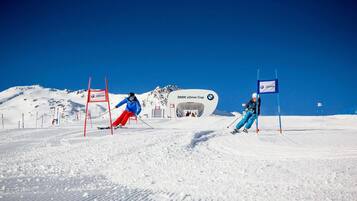 A ski slope with marked boundaries and a BMW xDrive Cup sign.
