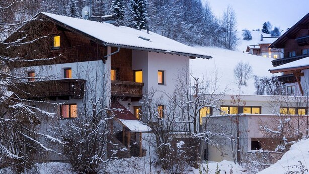 A snow-covered building with multiple balconies and windows, surrounded by trees and a snowy landscape. - Apartment in Serfaus-fiss-ladis (Ladis)