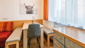 A modern kitchen with wooden cabinets, a bench, and a table. - Apartment in Serfaus-fiss-ladis (Ladis)