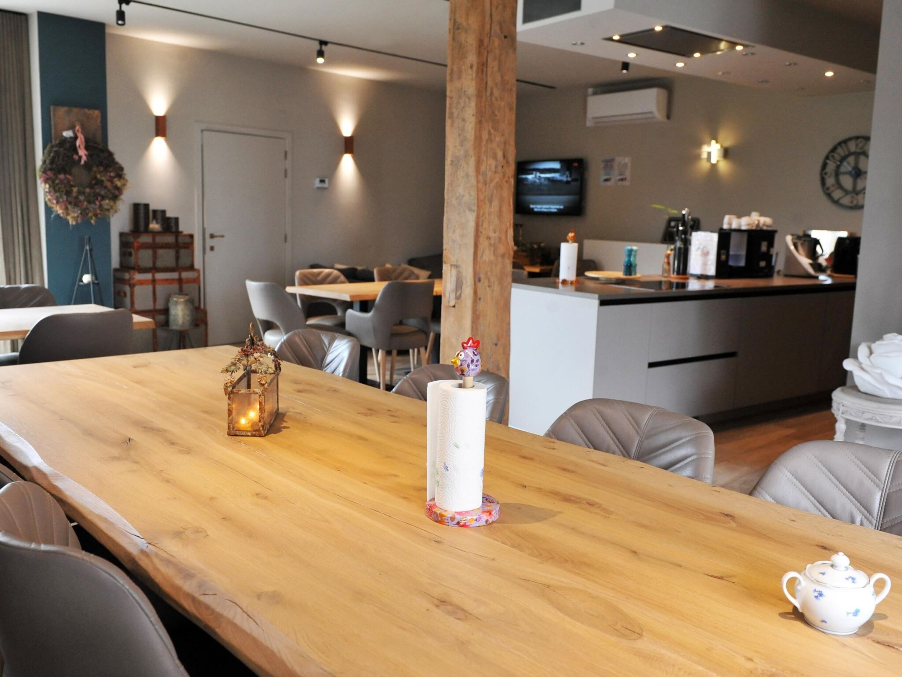A modern dining area with a wooden table, chairs, and a small decorative item.