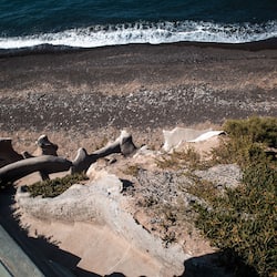On the beach, black sand, beach towels