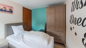 A bedroom with a bed, a wardrobe, and a wall with a motivational quote. - Holiday Home in Marche-en-famenne With Garden (Marche-en-Famenne)
