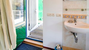 A bathroom with a sink, a mirror, and a green door. - Cozy Country Stay, Stoumont (Stoumont)