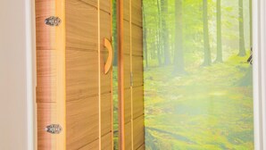 A wooden wardrobe with a forest mural on the door. - Gite Ma Dame Jeanne in Durbuy With a Sauna (Durbuy)