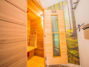 A wooden sauna with a door that opens to a forest mural. - Gite Ma Dame Jeanne in Durbuy With a Sauna (Durbuy)