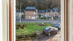 A view of a street with buildings, a car, and a grassy area. - Cosy Holiday Home in Hastiere With a Terrace (Hastiere)