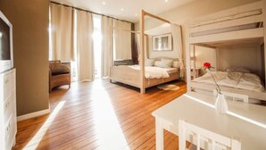 A bedroom with a four-poster bed, a bunk bed, a desk, and a chair. - Modern Holiday Home in Hastiere With Sauna (Hastiere)