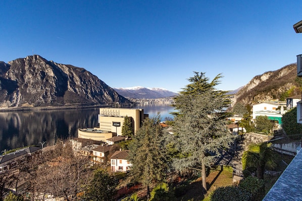 A mountainous landscape with a lake, buildings, and a prominent building with 'STELLA' signage.