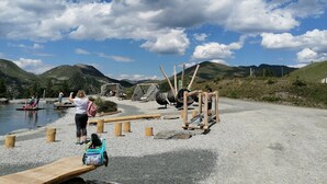 A lakeside area with wooden structures and a clear sky. - Holiday Home in Bad Kleinkirchheim (Bad Kleinkirchheim)