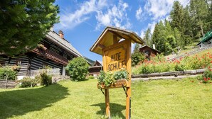 A traditional wooden building with a sign reading "ALTE SCHULE" in a lush, green setting. - Holiday Home in Bad Kleinkirchheim (Bad Kleinkirchheim)