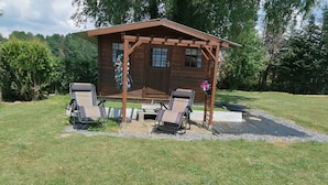 A wooden cabin with a pergola, two lounge chairs, and a small table. - Sweet Home in Chiny With Garden (Chiny)