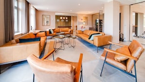 A spacious living area with multiple seating options, a billiards table, and a modern kitchen visible through an open doorway. - Luxury Stay; La Croix Scaille (Gedinne)