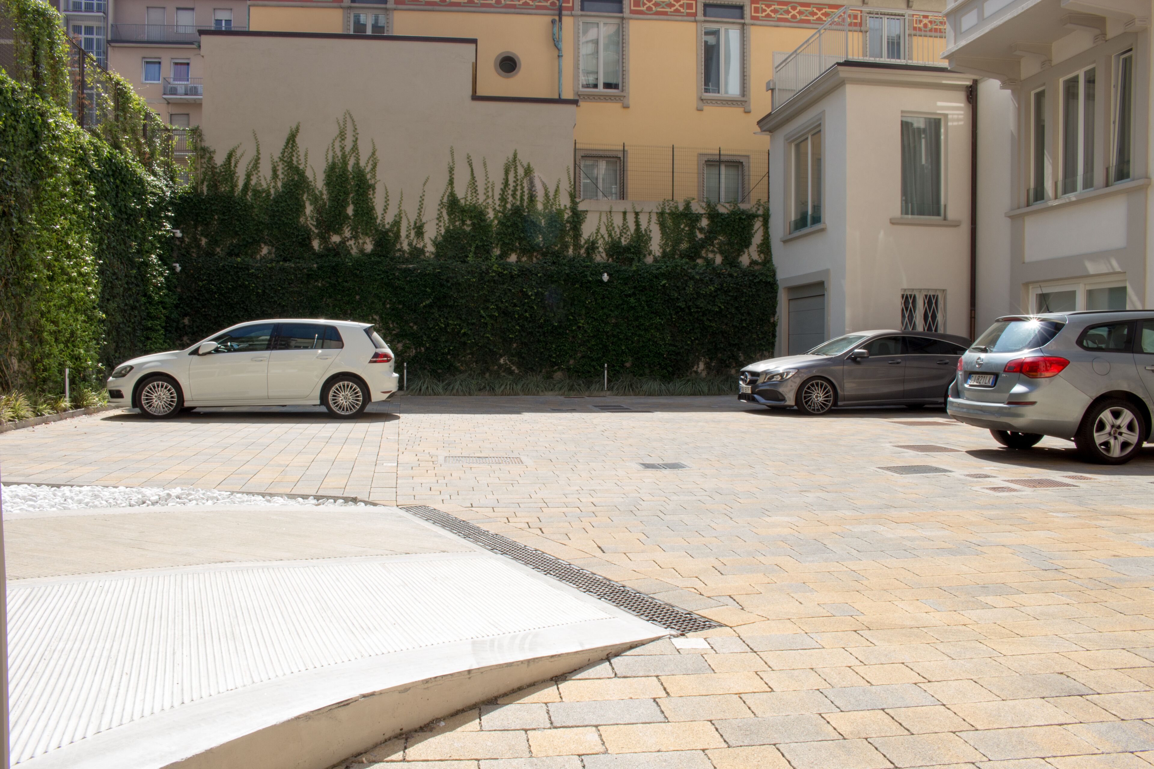 A parking area with three cars parked.