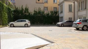 A parking area with three cars parked.
