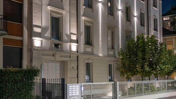 A multi-story building with a classic architectural style, featuring a symmetrical facade, large windows, and a gated entrance. - AR Boutique Apartments (Bergamo)
