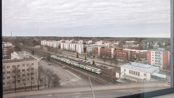 A train station with multiple tracks and a train in motion.