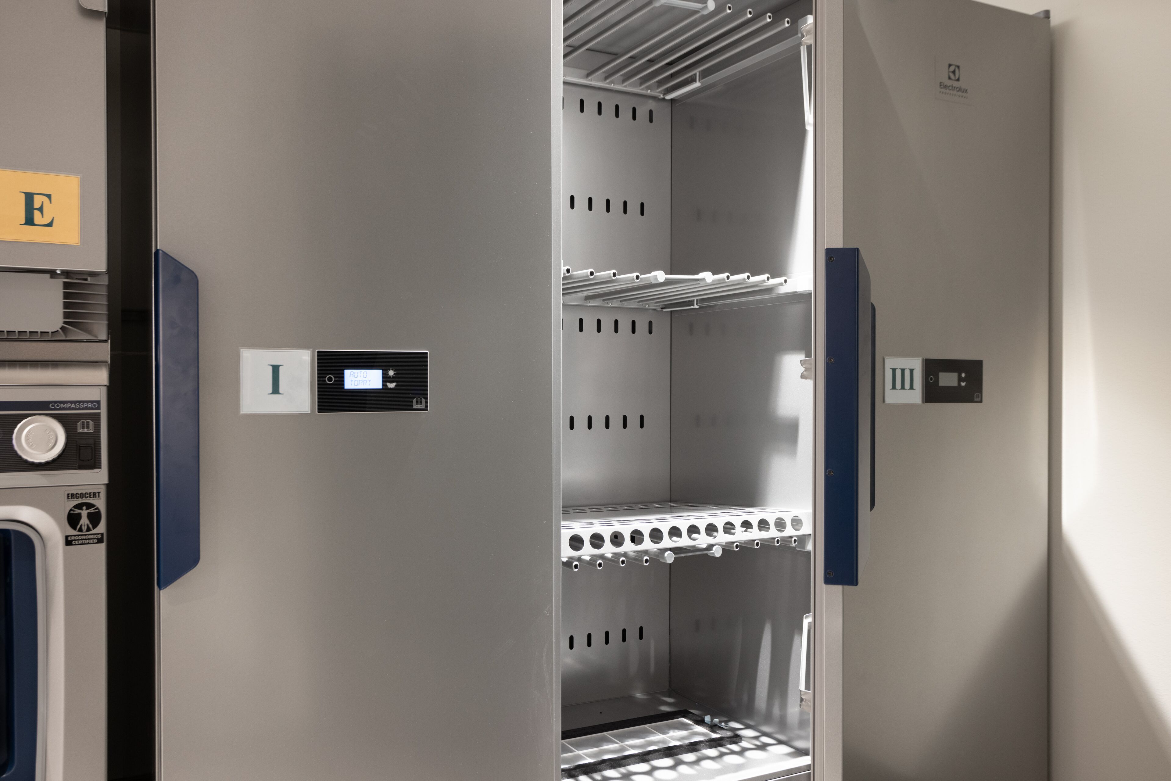 A compact, modern elevator with digital displays and a metal interior.
