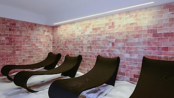 Relax in comfort with three plush chairs against a brick-patterned wall.