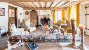 A cozy living room with wooden beams, a fireplace, floral upholstery, and a notepad on a table. - Welcoming Holiday Home in Vresse-sur-semois With Terrace (Vresse-sur-Semois)