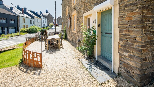 A stone building with a green door, a wooden table and chairs outside, and a gravel path. - Welcoming Holiday Home in Vresse-sur-semois With Terrace (Vresse-sur-Semois)