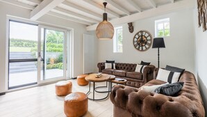 A spacious living area with a large sofa, ottomans, a coffee table, and a ceiling fan. - Spacious Family Holiday Home (Mont-de-l'Enclus)