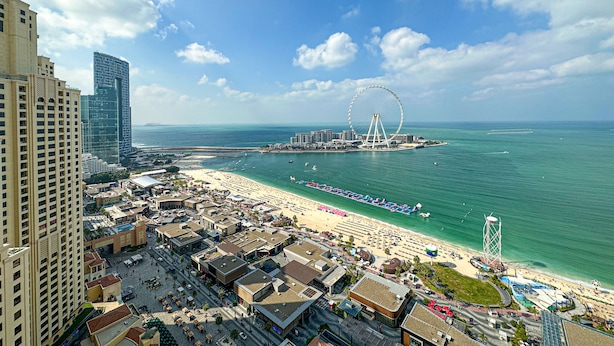 A coastal cityscape with a prominent Ferris wheel, beachfront, and high-rise buildings. - Marco Polo - Full Sea & Dubai Eye View | 2 BR | Near JBR Beach (Dubai)
