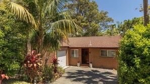 Set amidst lush greenery, this charming home offers a serene retreat.