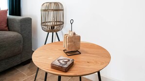 A round wooden table with a stack of books and a pair of glasses on it. - Holiday Home in Biron With Barrel Sauna (Erezee)