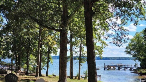 A lakeside setting with a dock, chairs, and a picnic table. - Lake Murray Cottage w/ Private Dock, Fire Pit & Kayaks - Near Martin's Landing (Prosperity)