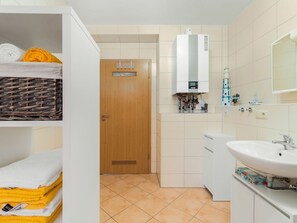 A bathroom with a white sink, a mirror, and a towel rack. - Apartment in Saxon With Terrace (Sebnitz)