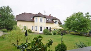 A two-story house with a tiled roof, a front porch, and a well-maintained lawn. - Tasteful Villa in Zernov With Private Pool (Žernov)