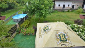 A backyard with a swimming pool, a tree, and a house. - Tasteful Villa in Zernov With Private Pool (Žernov)